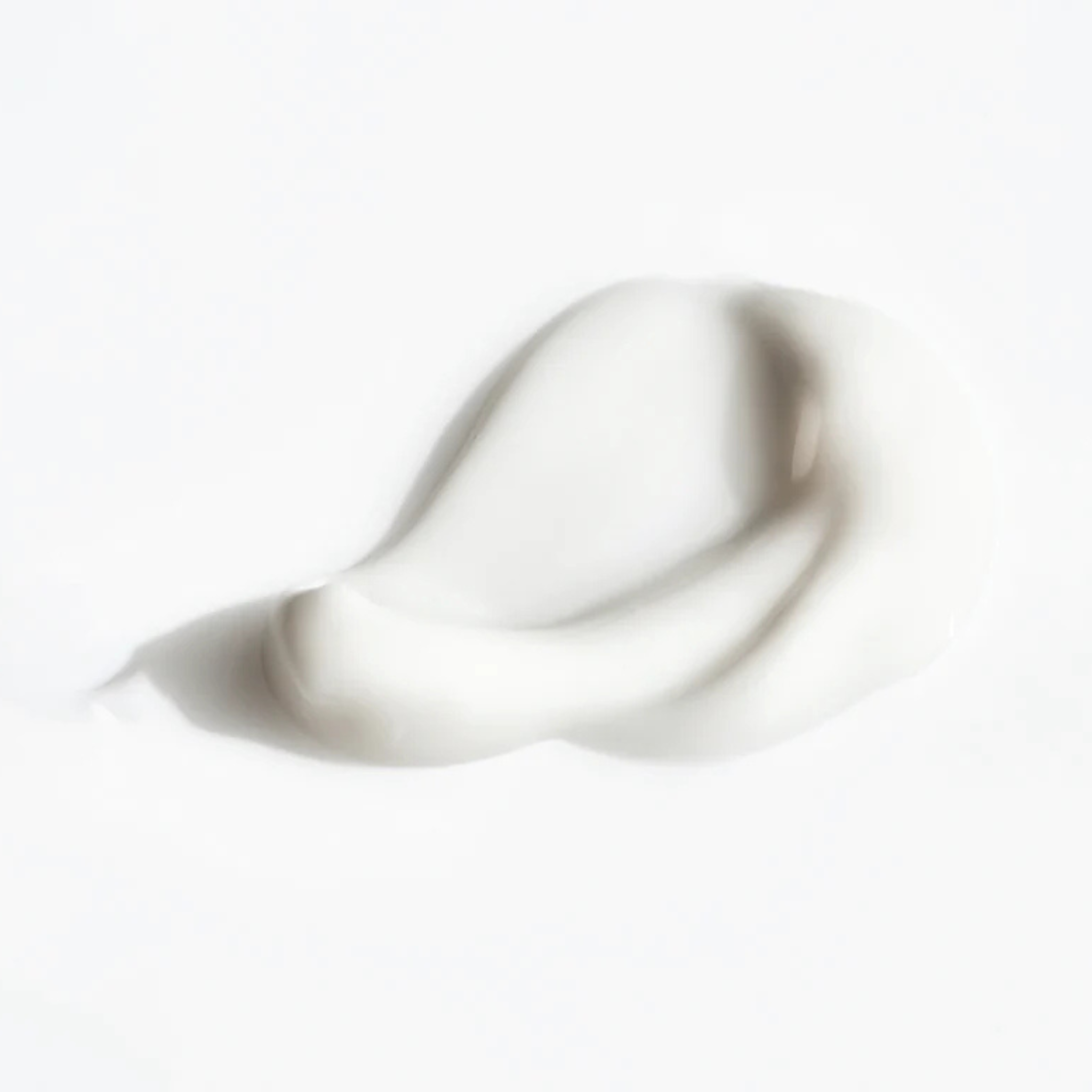 White cream with a wavy texture on a white background
